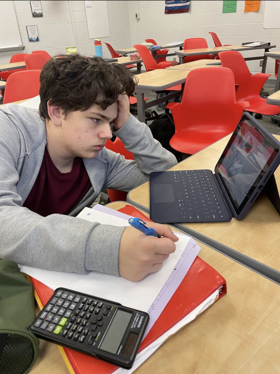 Sophomore Aiden Kiyar works on a question trail activity in Julie Coyne's Algebra II class to prepare for his quiz. Students studied quadratic equations and completed sample problems during the activity. "It’s way better than practicing outside of class.” Kiyar said. "It’s really hard to stay engaged if I’m practicing it outside of class. Doing it in the period makes it much easier to focus and absorb.”